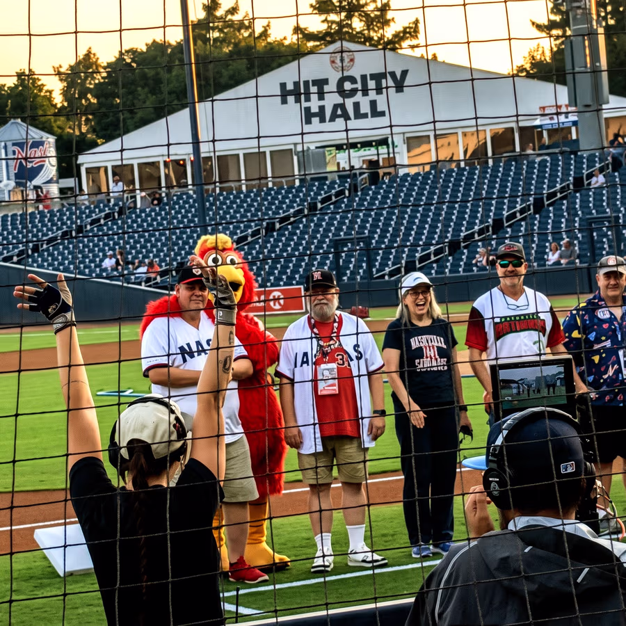 Paul standing on the field at First Horizon Park as an honorary member of the Silver Sounds.
